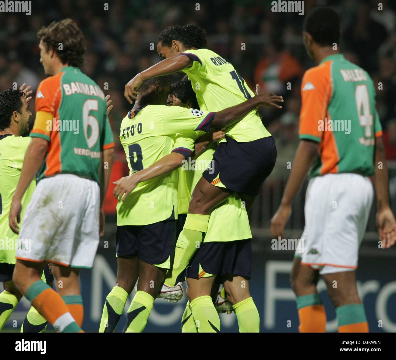 (dpa) - Players of Spanish soccer club FC Barcelona Samuel Eto'o (3rd from L) and Ronaldinho (2nd from R) congratulate their team mate Deco (C) after scoring 1-0 during the UEFA Champions League match SV Werder Bremen vs FC Barcelona at the Weser stadium in Bremen, Germany, Wednesday 14 September 2005. On the left Frank Baumann and on the right Naldo of Werder Bremen are pictured.  Stock Photo