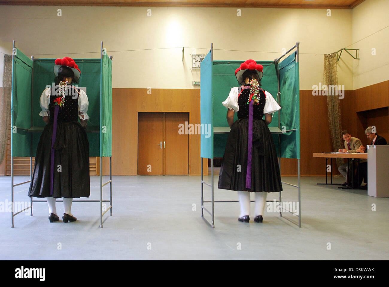 (dpa) - Dressed in their traditional Black Forest costume and wearing 'Bollenhats' Bettina Moser (L) and Susanne Kienzle (r) cast their ballots in Wolfach-Kirnbach; Germany, Sunday 18 September 2005. Around 62 million eligible voters will decide on a new Bundestag in Germany. Photo: P atrick Seeger Stock Photo