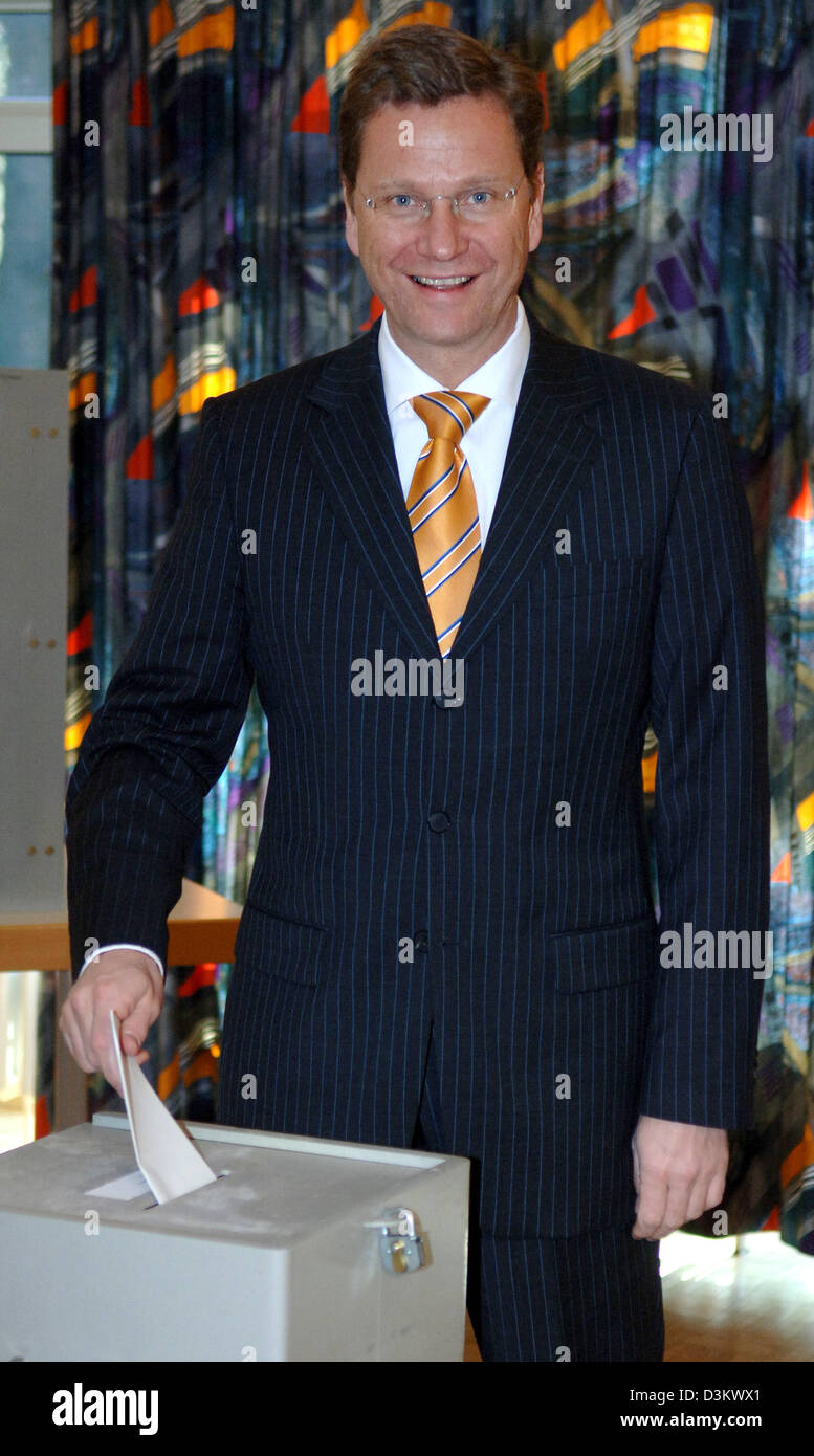 (dpa) - The chairman of the Liberal Party (FDP) Guido Westerwelle casts his vote for the Bundestag in a polling station in Bonn, Germany, Sunday, 18 September 2005. According to the last polls prior to the election the FDP can expect between six and eight per cent. Photo: Felix Heyder Stock Photo