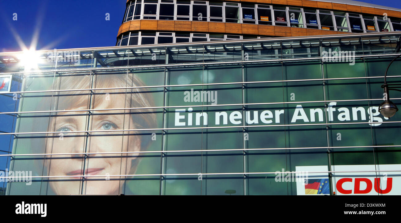 (dpa) - The sun rises and mirrors on the facade of the headquarter of the Christian Democratic Party (CDU) in Berlin, 18 September 2005. The poster attached to the facade features a portrait of Angela Merkel, chairwoman of the CDU and chancellor candidate. Supporters and journalists are going to follow the election results of the 2005 German Bundestag election at the  party headqua Stock Photo