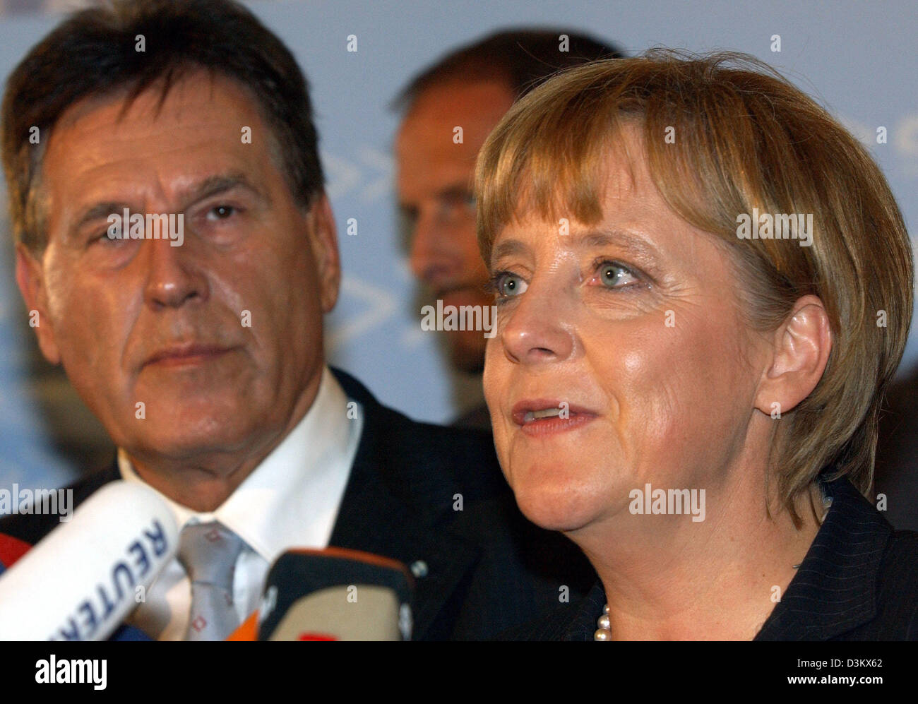 (dpa) - Angela Merkel (R), Chairwoman of the CDU and chancellor candidate, stands next to Michael Glos, Head of the Bavarian CSU, during a short press conference after the session of the new elected parliamentary faction of the CDU/CSU in Berlin, Tuesday, 20 September 2005. Despite the week results in the general election for the German Bundestag, Merkel was re-elected by her party Stock Photo