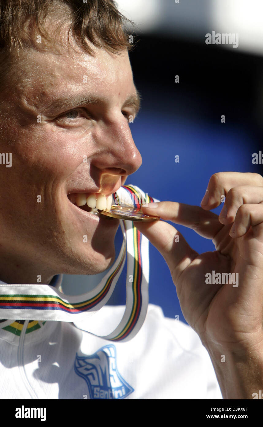 (dpa) - Russian cyclist Michael Ignatiev bits his gold medal after winning the men's single time trial race in the under 23 class at the Cycling World Championship in Madrid, Spain, Wednesday, 21 September 2005. The tour covered a distance of 37,9 kilometres. Photo: Bernd Thissen Stock Photo