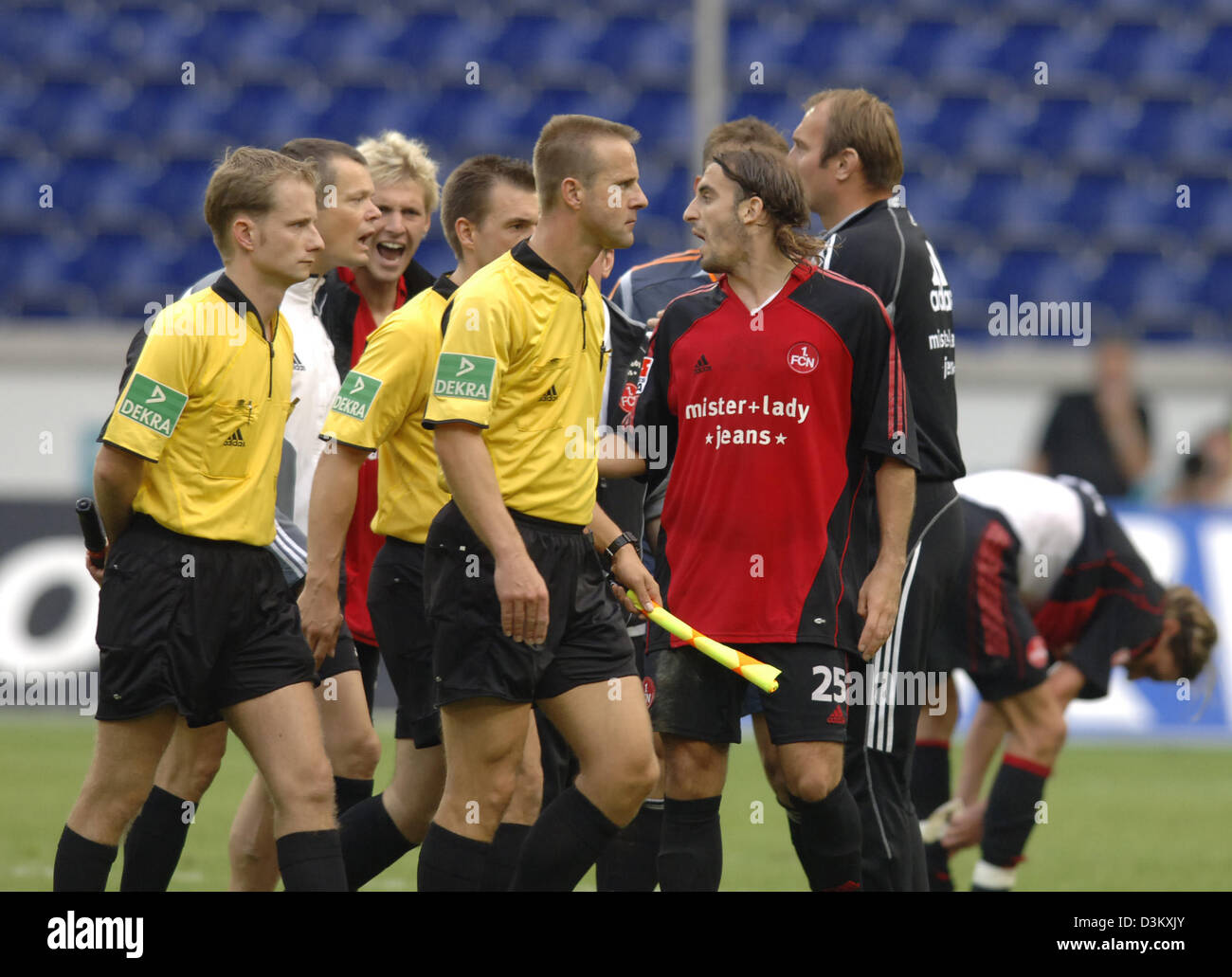 (dpa) - 1.FC Nuremberg's players Stefan Kiessling (3rd from L) and Javier Pinola (3rd from R) verbally attack referee Peter Gagelman after the Bundeliga match against MSV Duisburg at the MSV Arena stadium in Duisburg, Germany, 24 September 2005. Referee Gagelmann faced the criticism because he had not acknowledged a goal of Nuremberg. Photo: Achim Scheidemann Stock Photo