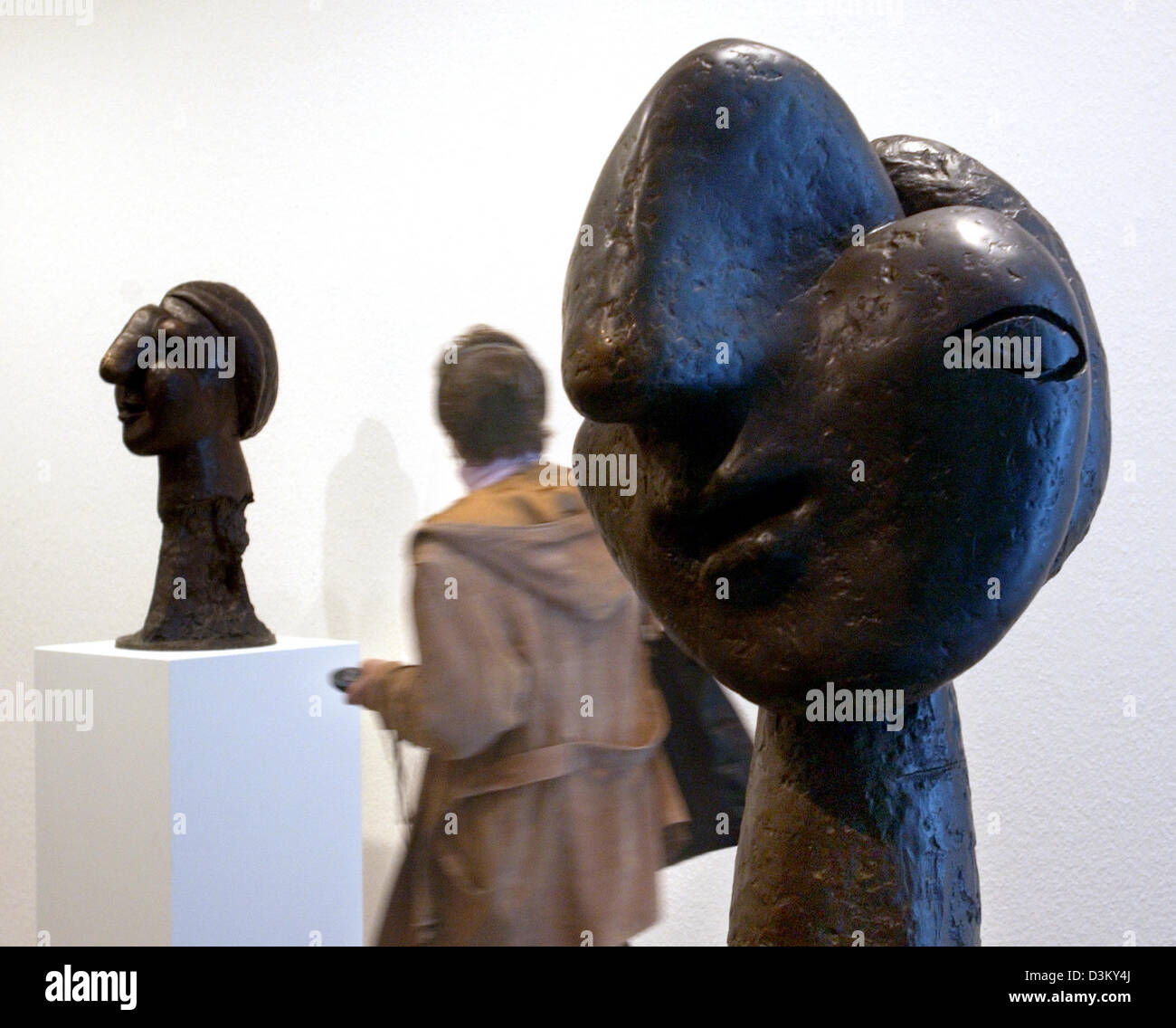 dpa) - A visitor passes sculptures of the Spanish artist Pablo