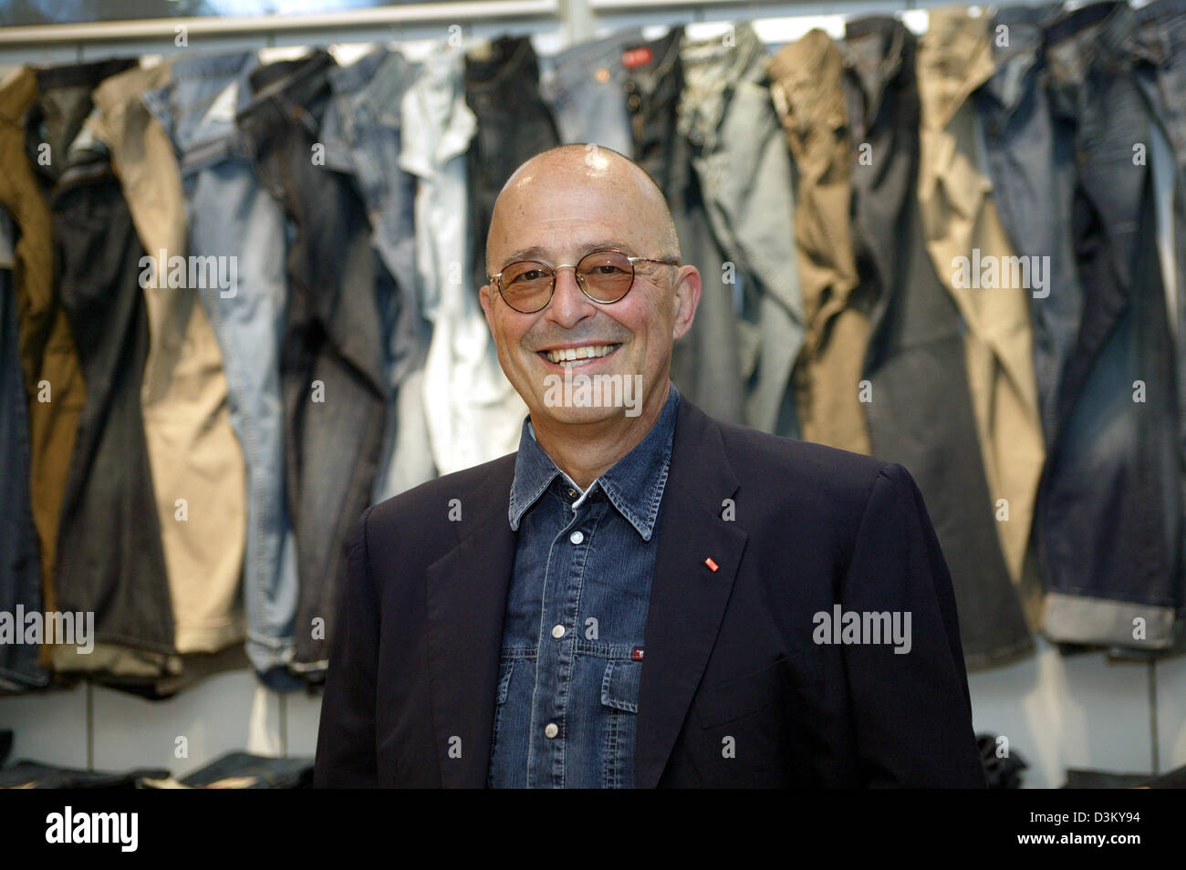 (dpa file) - Heiner Sefranek, CEO of clothing retailer Mustang, stands smiling in front of shelves of clothing of the denim brand Mustang at the company's headquarter in Kuenzelsau, Germany, 06 April 2005. Photo: Harry Melchert Stock Photo