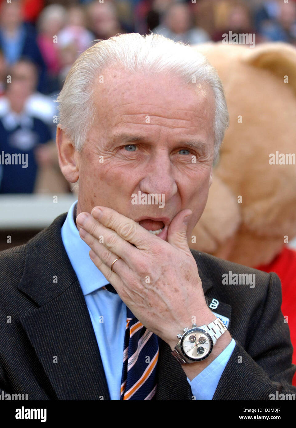 (dpa) - Coach of Stuttgart, Giovanni Trapattoni, touches his face at