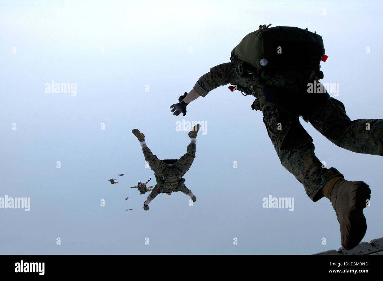 US Marines parachute jump out of the back of a KC130J Hercules
