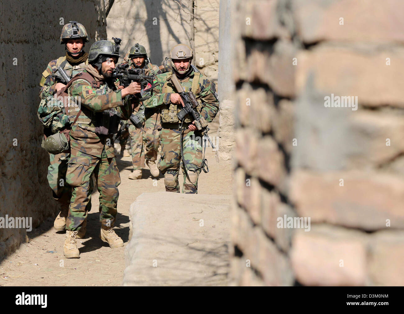 Afghan National Army commandos with the 6th Special Operations Kandak patrol an alley February 12, 2013 in Tagab district, Kapisa province, Afghanistan, Feb. 12, 2013. Stock Photo