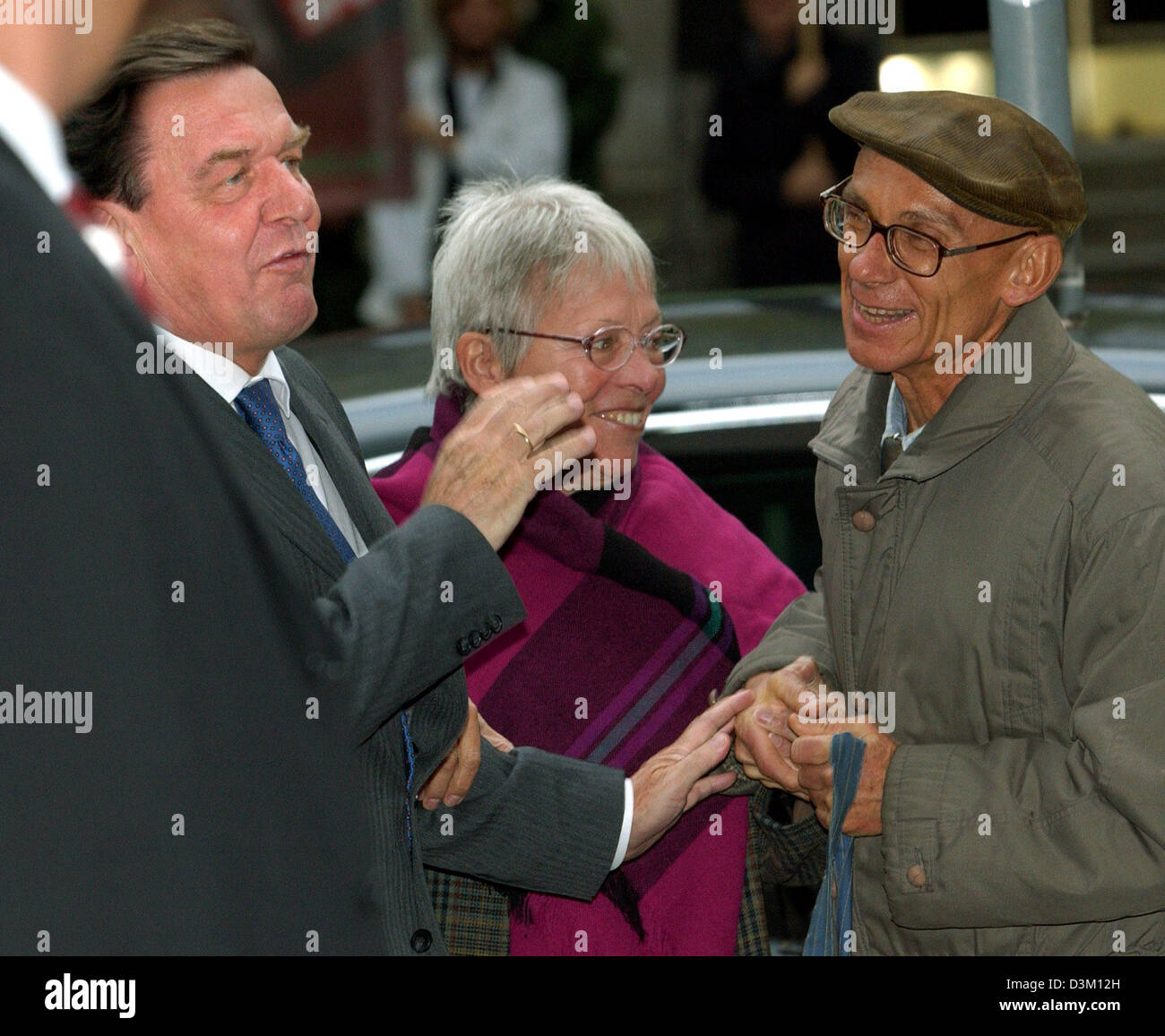 (dpa) - German Chancellor Gerhard Schroeder is welcomed by passers-by at his arrival to the exploratory talks with CDU at the SPD party headquarter in Berlin, Germany, Monday 17 October 2005. Photo: Stephanie Pilick Stock Photo
