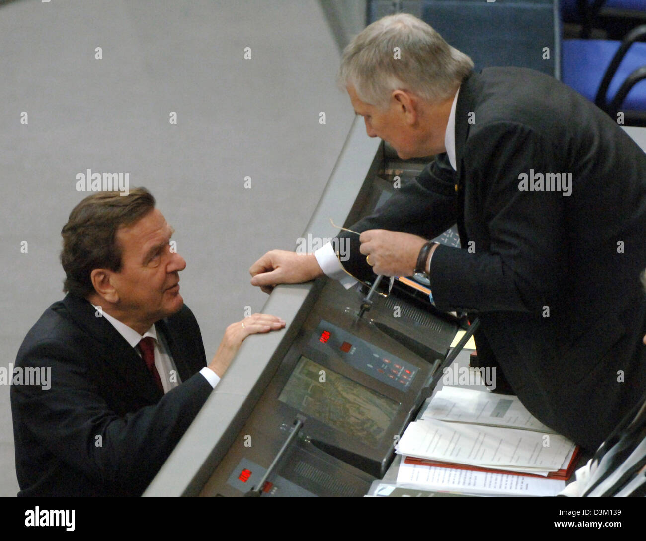 (dpa) - German Chancellor Gerhard Schroeder (L) talks to German Minister of the Interior Otto Schily ahead of the first session of the new Bundestag parliament at the Reichstag in Berlin, Germany, Tuesday, 18 October 2005. The parliament has come together for the first time since the general election for the German Bundestag in September, in order to elect the new President of the Stock Photo