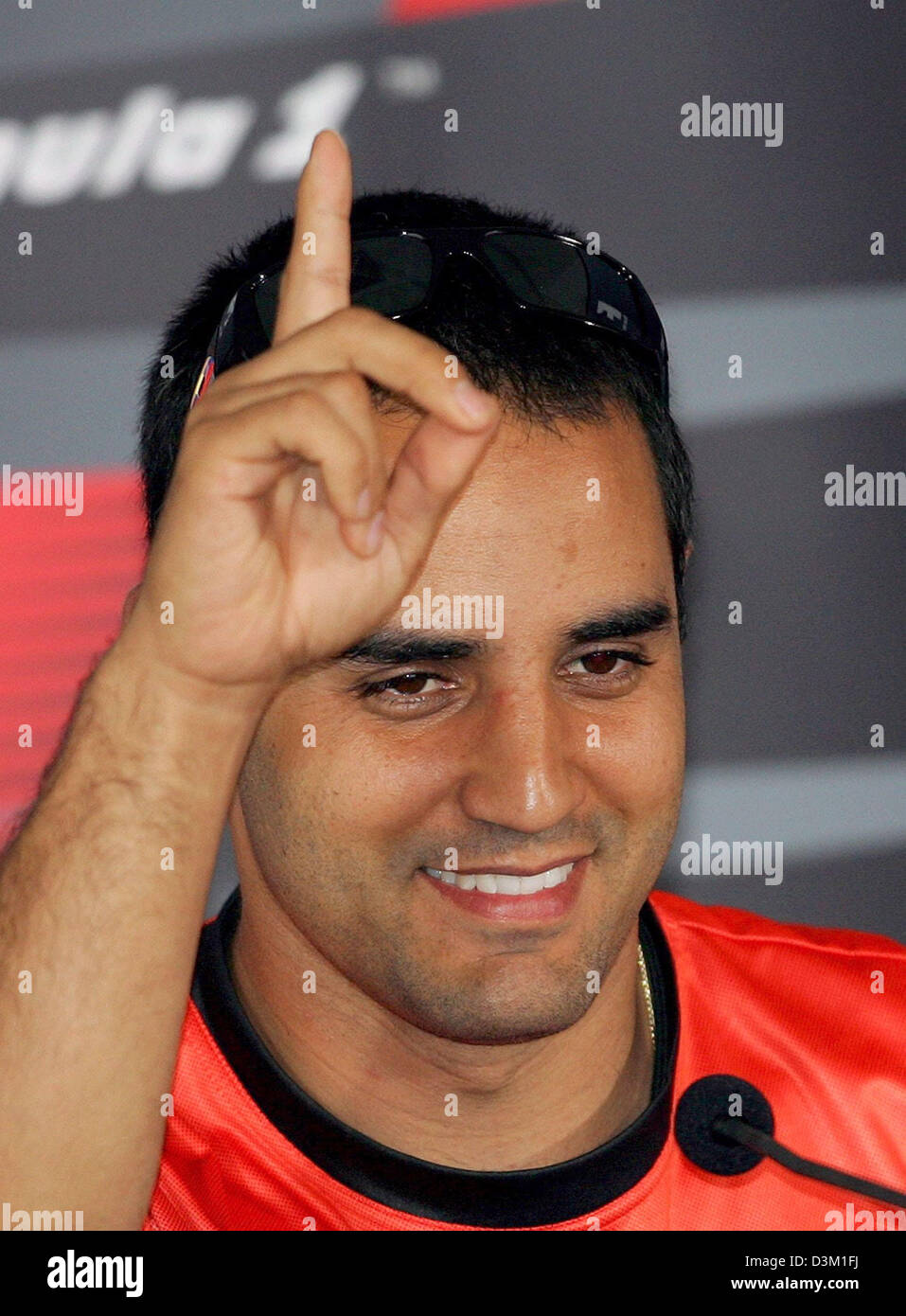 (dpa) - Columbian Formula One driver Juan Pablo Montoya of Team McLaren-Mercedes smiles and point upwards with his finger as he takes part in a püress conference at the Formula One circuit in Shanghai, China, 13 October 2005. The final race of this year's Formula One season starts here on Sunday, 23 October 2005. Photo: Kerim Okten Stock Photo