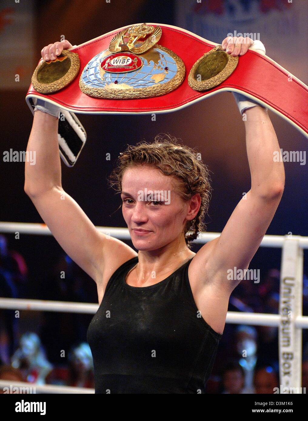 (dpa) - German boxer Ina Menzer (Moenchengladbach) shows the WIBF featherweight champion belt after her fight vs titleholder Silke Weikenmeier (Speyer) in the sport hall Branberge in Halle, Germany, 22 October 2005. The 24-year-old Menzer of the Universum scion Spotlight won the fight after 10 rounds to points and secured the WIBF belt in her eleventh victorious fight. Photo: Peter Stock Photo