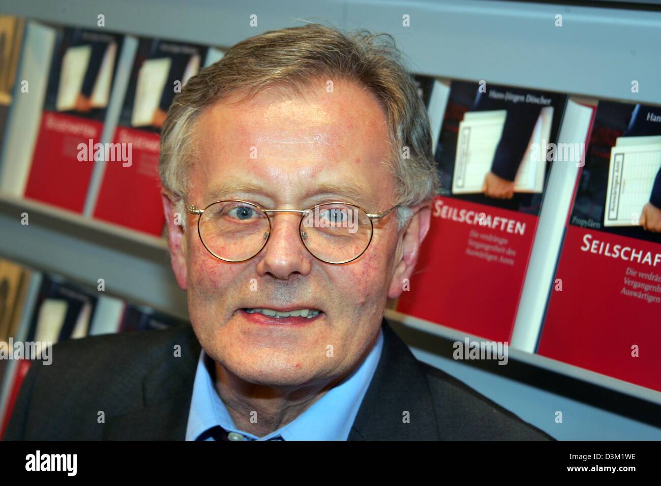 (dpa) - Historian and author Hans-Juergen Doescher pictured at the Frankfurt Book Fair in Frankfurt, Germany, 20 October 2005. In the background stand specimens of his newest book 'Insider relationships. The repressed history of the Foreign Office'. Photo: Uwe Zucchi Stock Photo