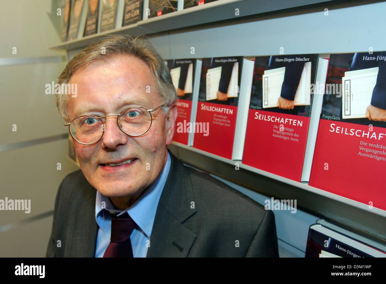 (dpa) - Historian and author Hans-Juergen Doescher pictured at the Frankfurt Book Fair in Frankfurt, Germany, 20 October 2005. In the background stand specimens of his newest book 'Insider relationships. The repressed history of the Foreign Office'. Photo: Uwe Zucchi Stock Photo