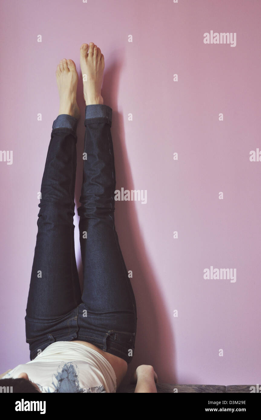 Woman lying on bed with her feet up Stock Photo Alamy