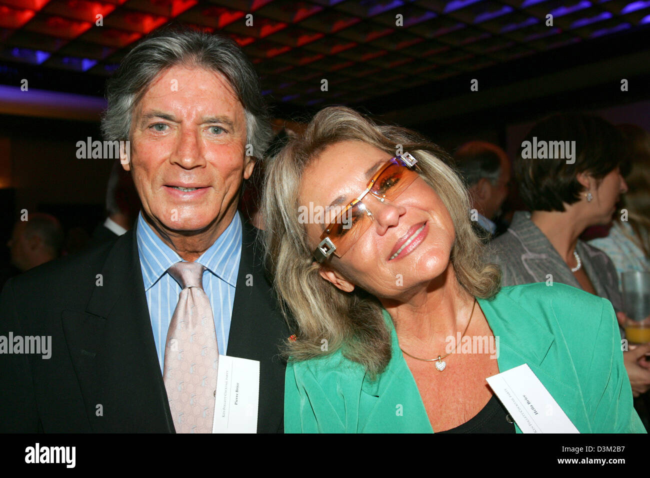 (dpa) - French actor and author Pierre Brice (L), who wrote his autobiography and his wife Hella Krekel pictured at the Luebbe cocktail reception in honour of US author Ken Follett at the international book fair in Frankfurt, Germany, 19 October 2005. Photo: Uwe Zucchi Stock Photo