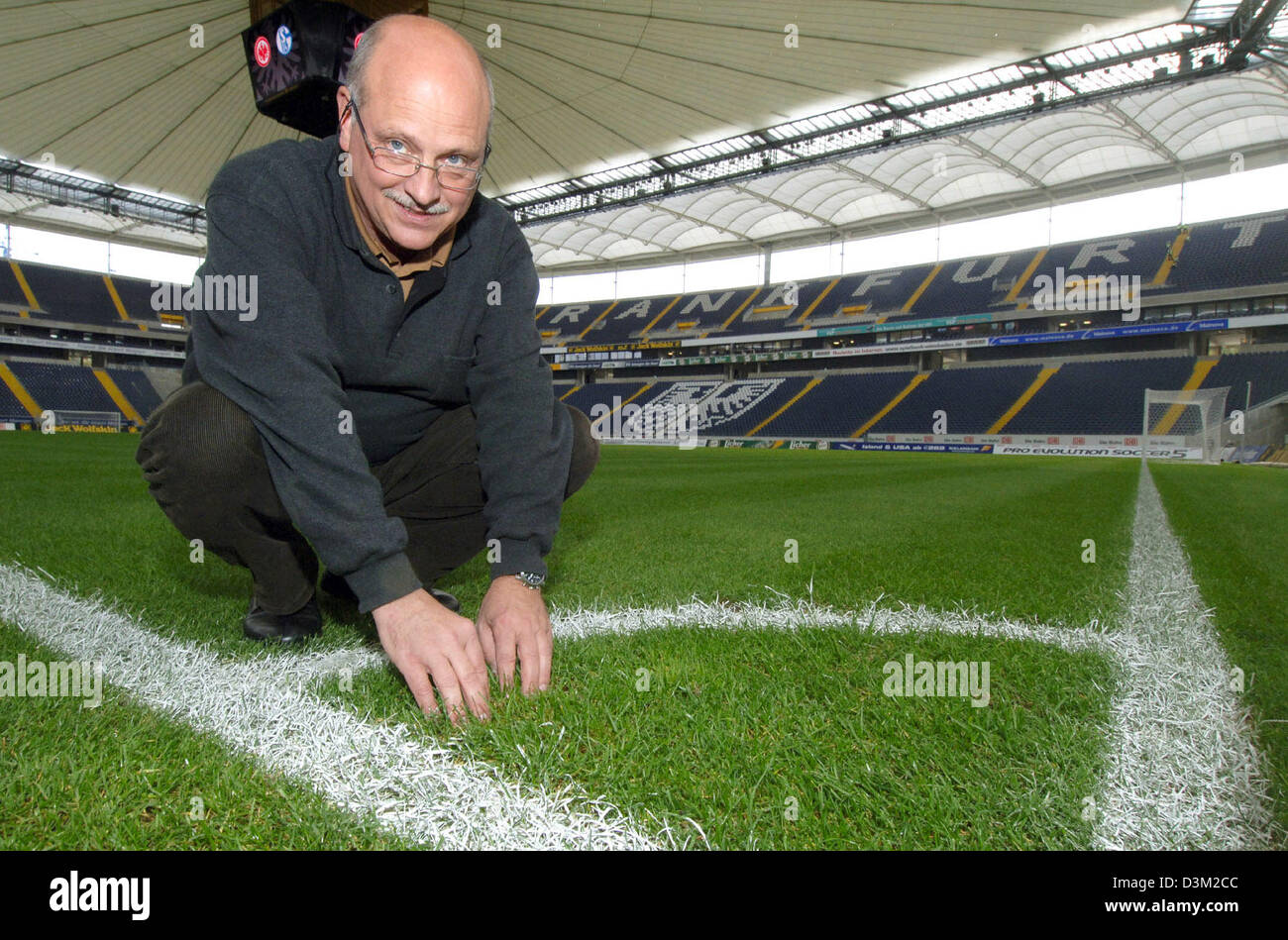 (dpa) - The picture shows Rainer Ernst smiling on the turf at the Commerzbank Arena stadium in Frankfurt Main, Germany, Tuesday 25 October 2005. Ernst is member of the so-called 'Grass expert team', which is responsible to ensure the best possible grass turf pitches inside German soccer stadiums that host FIFA World Cup matches in 2006. Photo: Werner Baum Stock Photo