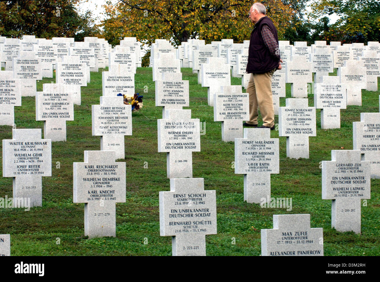 (dpa) - The picture shows a visitor at the German military cemetary near the Alsatian city of Bergheim, France, 25 October 2005. The cemetary was inaugurated in November 30 years ago. Before, the killed soldiers were buried in 225 different Alsatian communities. Over 5,300 soldiers rest at the cemetary; most of them died in 1944/45. Photo: Rolf Haid Stock Photo