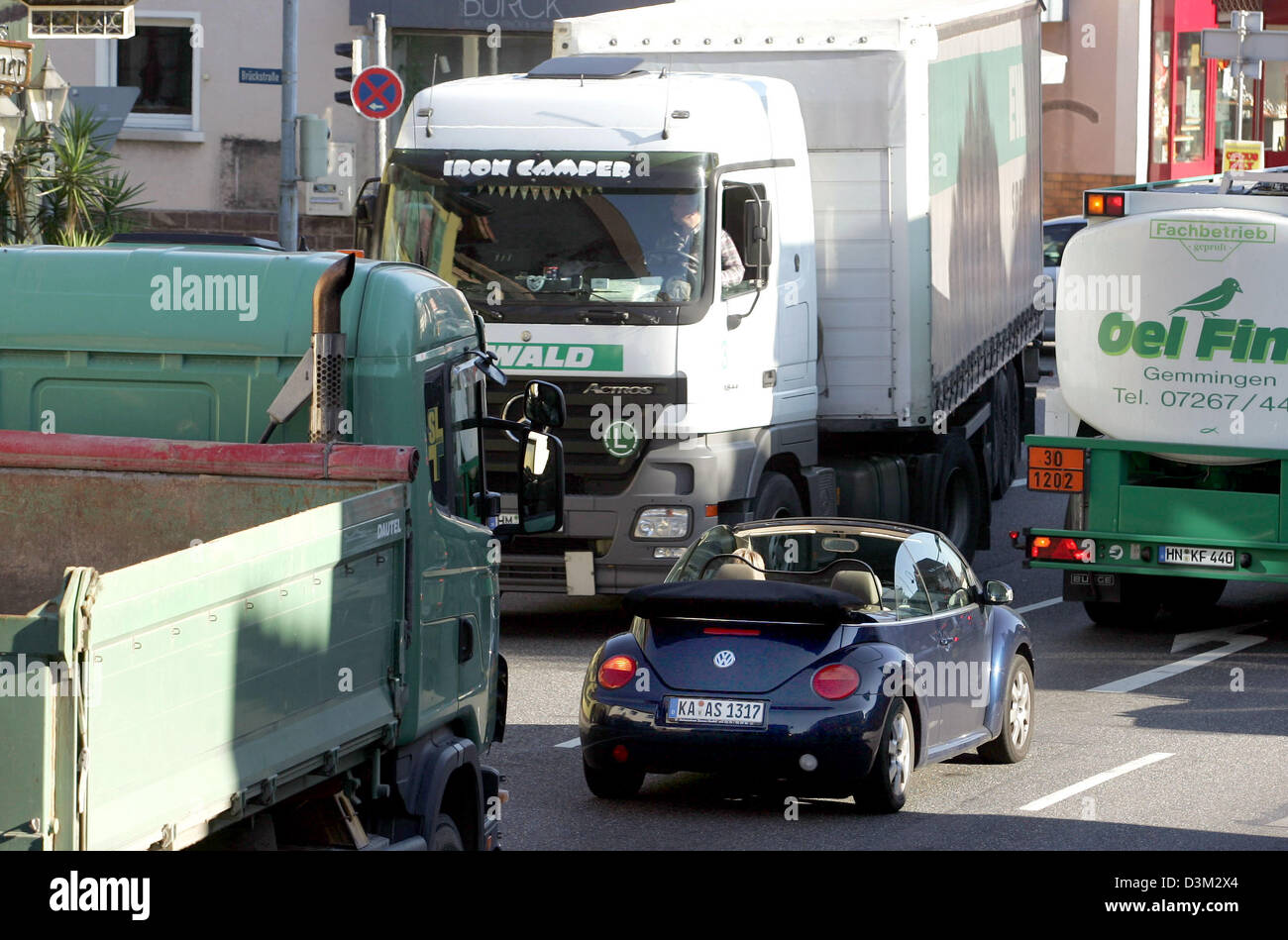(dpa) - Trucks and cars move slowly along the federal road B10 through the town of Groetzingen, Germany, Friday, 29 October 2005. The introduction of the motorway toll for trucks and lorries has caused a shift in heavy goods traffic from motorways to federal roads in Germany's southwest. Rudolf Koberle of the conservative CDU and State secretary for Traffic and Transport of the sta Stock Photo