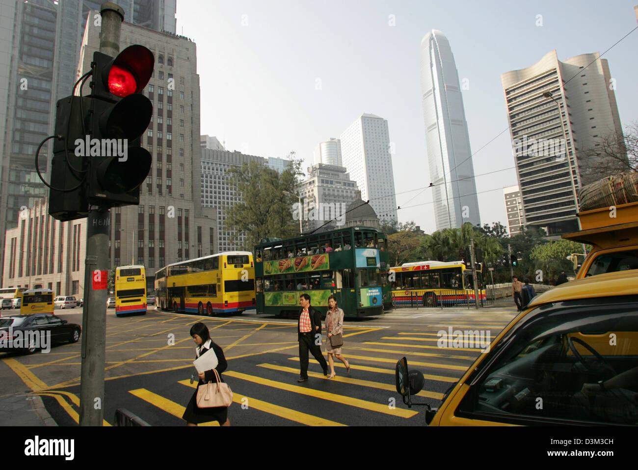 (dpa files) - Pedestrians walk across a zebra crossing in Hong Kong, China, 28 October 2004. The high rise (2nd from R) is the so-called International Finance Centre, which marks with a hight of 415 metres the tallest building of the city. Hong Kong, which has a population of 7,5 million, had been under British administration until it became the Hong Kong Special Administrative Reg Stock Photo