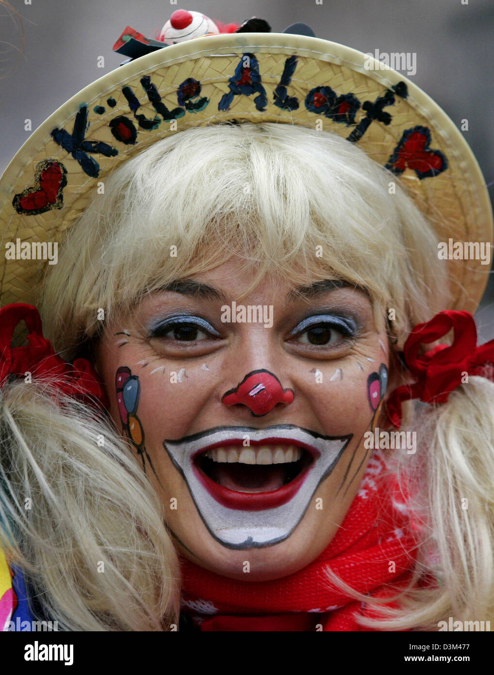 (dpa) - A young woman dressed up as a clown celebrates the carnival season kick-off at 11:11 o'clock at Heumarkt square in Cologne, Germany, Friday 11 November 2005. Several thousands of people celebrated the start of the 'fifth season' on the streets of the German carnival stronghold Cologne. Photo: Roland Weihrauch Stock Photo