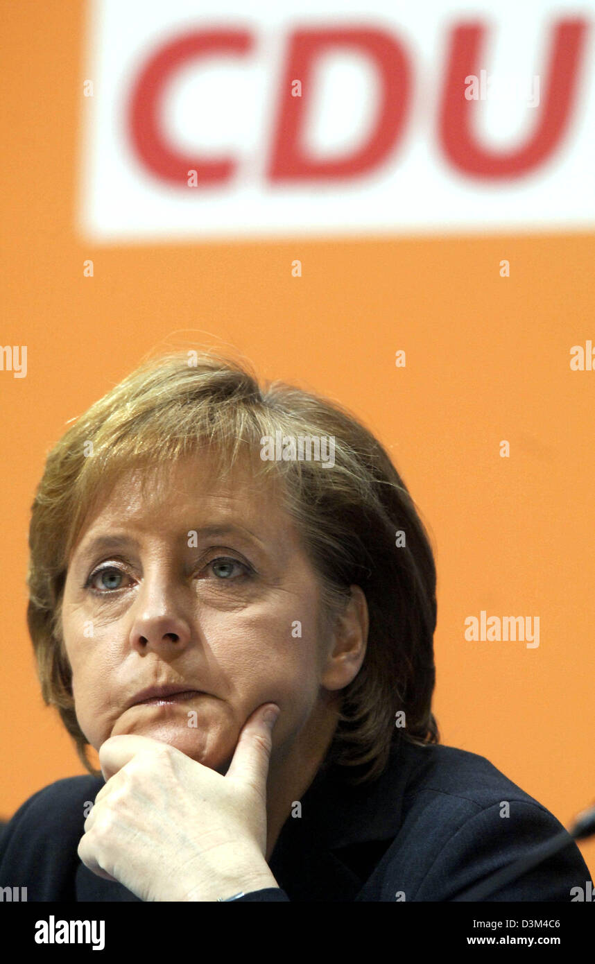 (dpa) - CDU Chairwoman and designated German Chancellor Angela Merkel sits at the podium during the CDU's small party convention in Berlin, Germany, 14 November 2005. Merkel defended the formation of a grand coalition. Photo: Tim Brakemeier Stock Photo