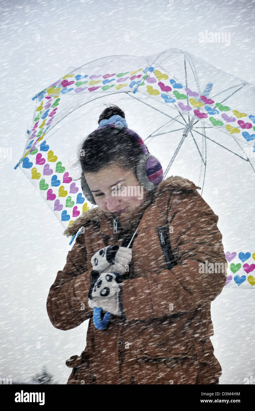 Young woman caught up in a snow storm Stock Photo