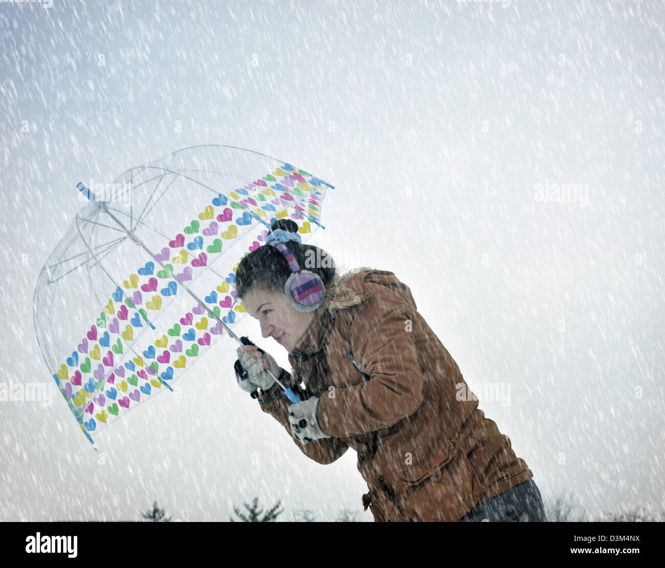 Young woman caught up in a snow storm Stock Photo