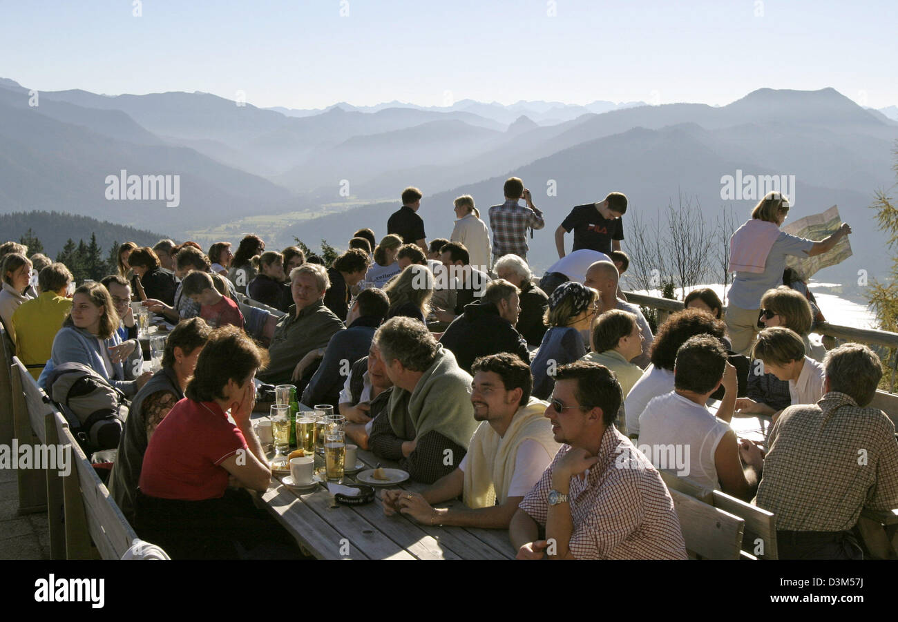(dpa) - Hikers have a rest in 1,263 metres altitude at the sun terrace of Neureuthaus restaurant at Neureut mountain near lake Tegernsee, Germany, 30 october 2005. Photo: Stephan Goerlich Stock Photo