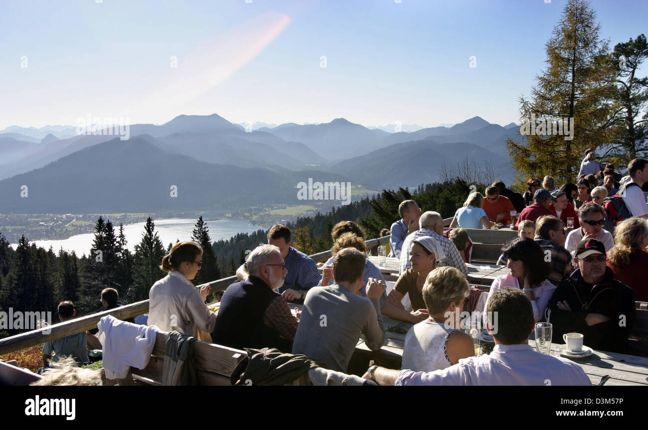 (dpa) - Hikers have a rest in 1,263 metres altitude at the sun terrace of Neureuthaus restaurant at Neureut mountain near lake Tegernsee (back), Germany, 30 October 2005. Photo: Stephan Goerlich Stock Photo