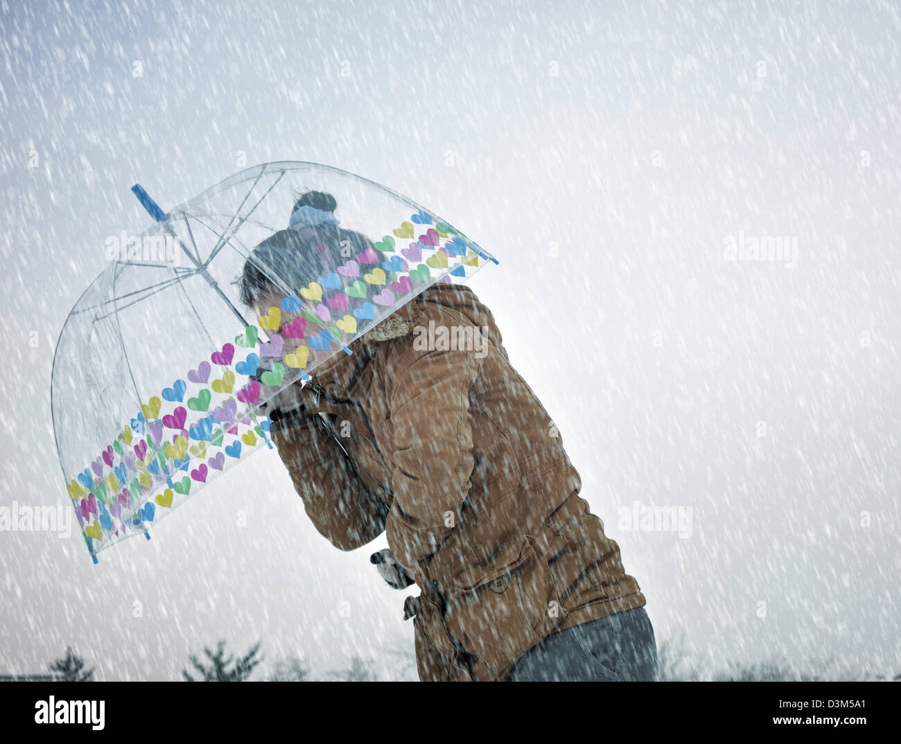 Young woman caught up in a snow storm Stock Photo