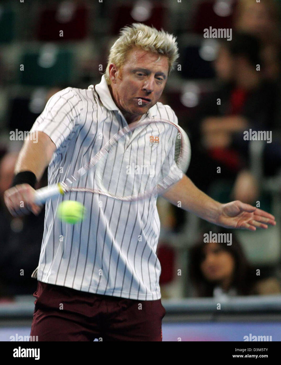 dpa) - Former tennis ace Boris Becker plays a backhand as he plays against  his former French centre court rival Henri Leconte in a show tennis match  in Bremen, Germany, Sunday, 27