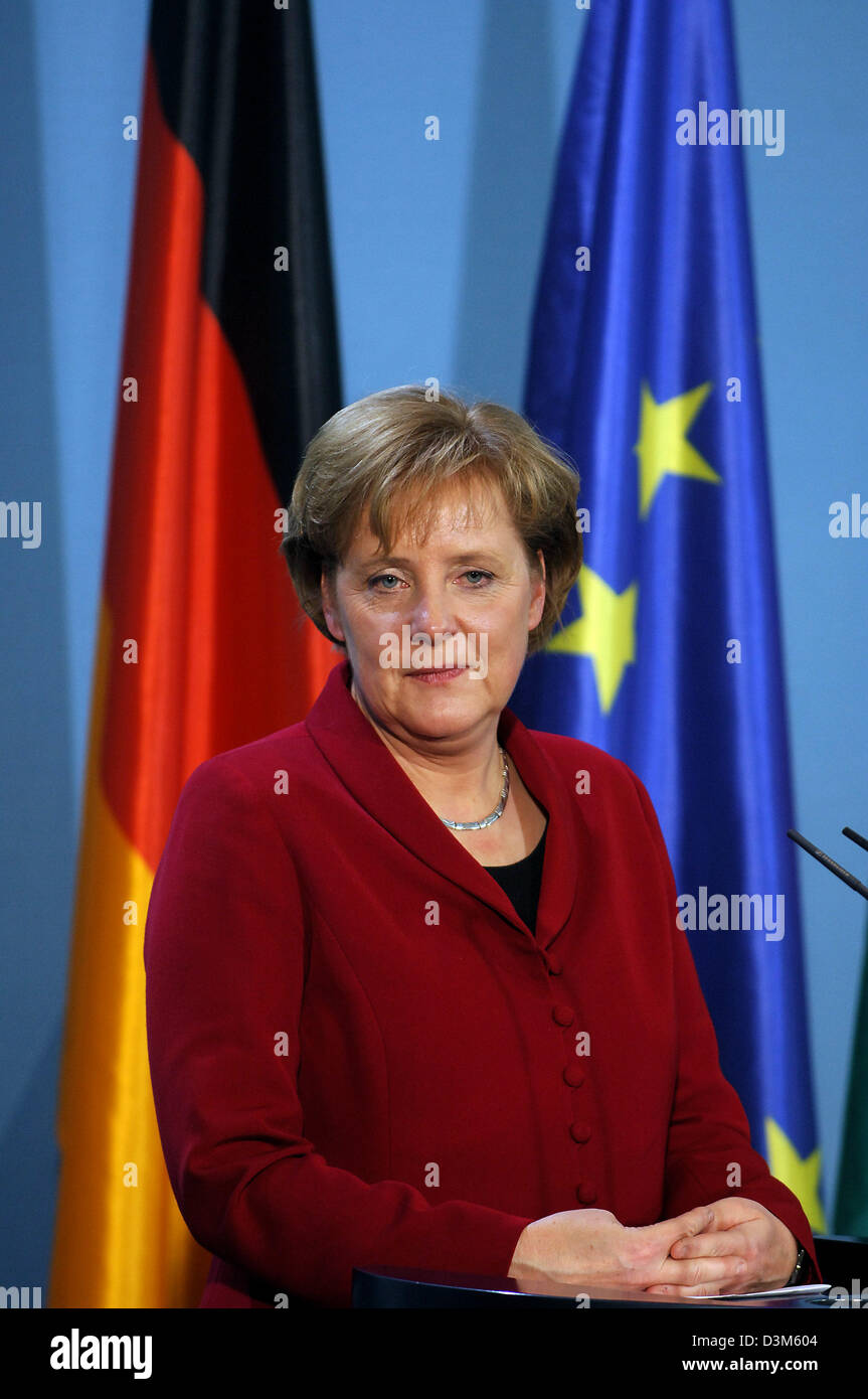 (dpa) - The picture shows German Chancellor Angela Merkel in front of the German and the European flag during a press conference at the Chancellery in Berlin, Germany, Monday, 28 November 2005. Photo: Peter Kneffel Stock Photo