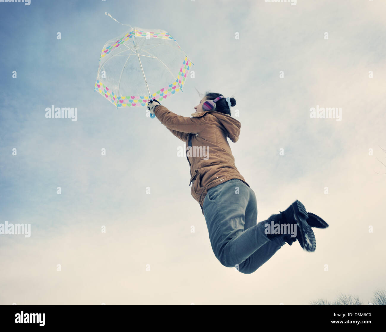 Woman with umbrella jumping Stock Photo - Alamy