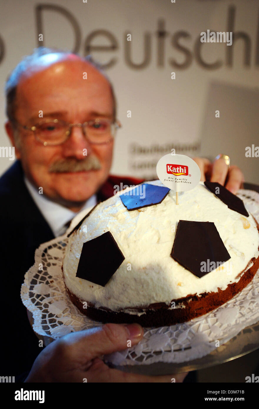 (dpa) - Rainer Thiele, manager of food producer Kathi, presents a 'soccer cake' in Leipzig, Germany, 08 December 2005. It is Germany's only soccer cake which customers can bake themselves, according to Thiele. About 4,000 guests, among them 1,500 journalists, are expected for the FIFA World Cup 2006 main draw in Leipzig on Friday 09 December. Photo: Michael Hanschke Stock Photo