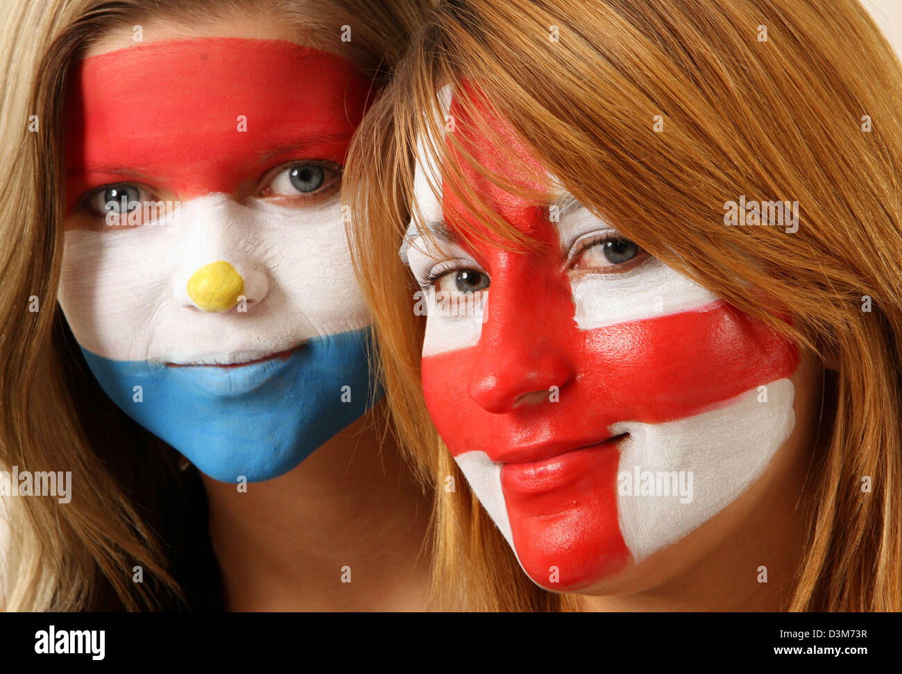 (dpa) - Claudia (L) featuring the national colours of Paraguay painted on her face and Julia, the national colours of England representing the first match of the Soccer World Cup on 10 June 2006 pictured in Frankfurt, Germany, 09 December 2005. Millions of people followed the main drawing of the lots which took place in Leipzig, Germany. Photo: Boris Roessler Stock Photo
