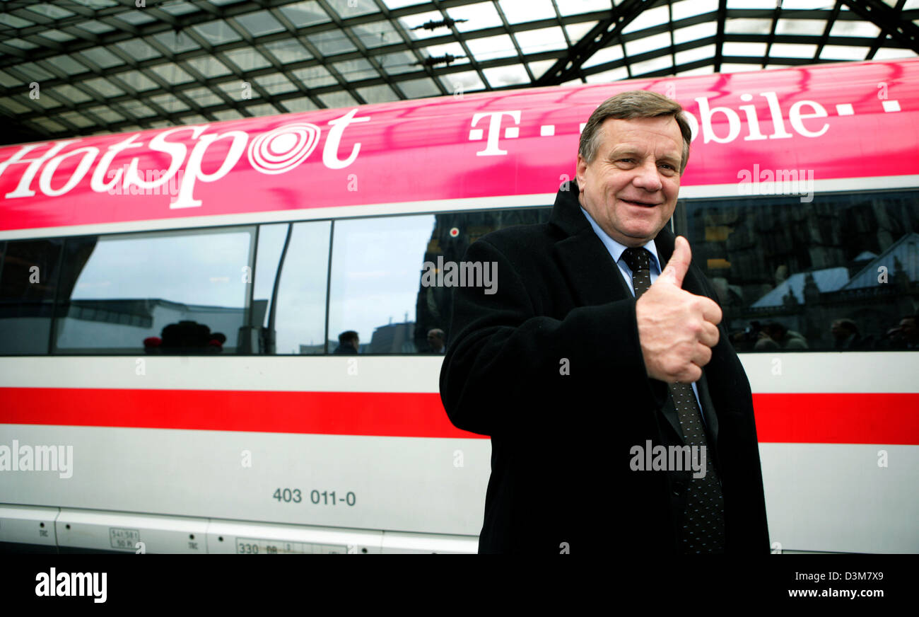 (dpa) - CEO of the German Railway, Hartmut Mehdorn, gives thumps up standing in front of the first Intercity Express (ICE) train equipped with a HotSpot of the German Telecom in the Central Station of Cologne, Germany, Tuesday 20 December 2005. The two companies test the highspeed internet access pilot project joint venture on the track between Dortmund and Cologne where passengers Stock Photo