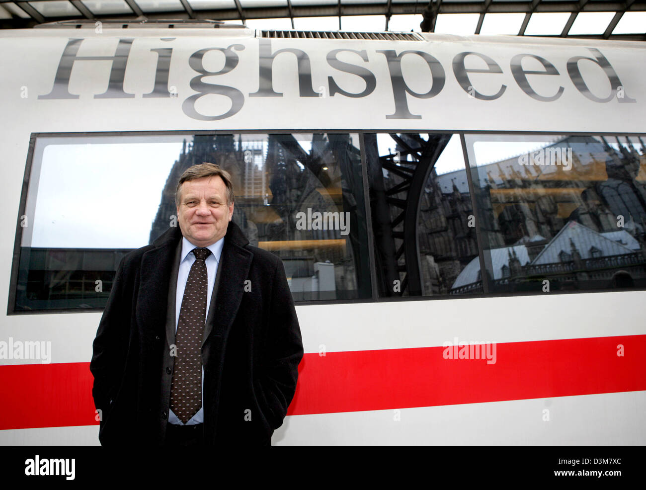 (dpa) - CEO of the German Railway, Hartmut Mehdorn, stands in front of the first Intercity Express (ICE) train equipped with a HotSpot of the German Telecom in the Central Station of Cologne, Germany, Tuesday 20 December 2005. The two companies test the highspeed internet access pilot project joint venture on the track between Dortmund and Cologne where passengers can access the in Stock Photo