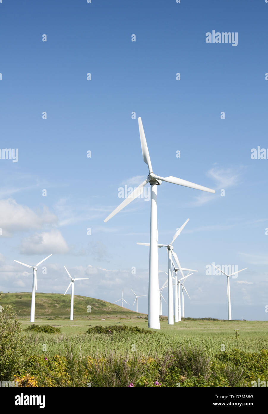 Wind turbines blue sky and lush green landscape Stock Photo - Alamy