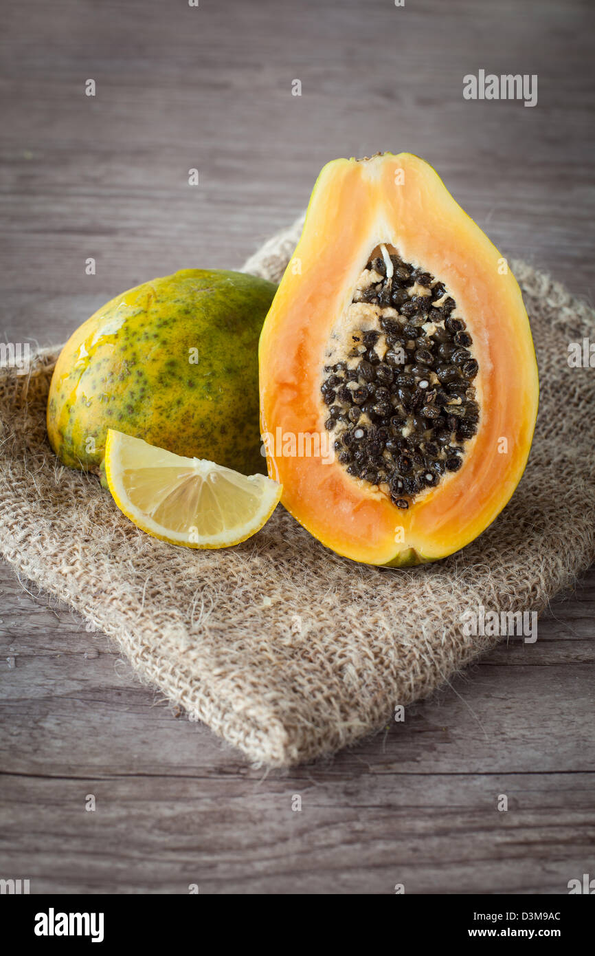 Sliced fresh papaya fruit on wooden background Stock Photo
