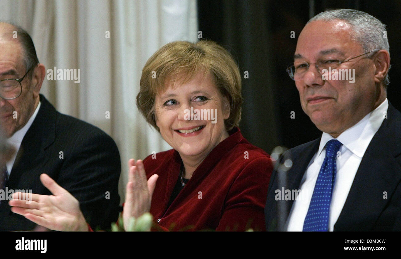 (dpa) - German Chancellor Angela Merkel (L) smiles next to Colin Powell, former secretary of state, during a reception at the German embassy in Washington, USA, 12 January 2006. Merkel will couple criticism of the U.S. prison in Guantanamo Bay with a vow to do more to help stabilise Iraq when she meets President George W. Bush on Friday, a senior German diplomat said. Photo: Michae Stock Photo