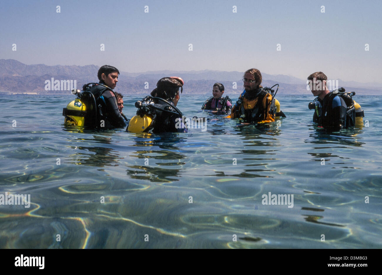 Beginners in diving instructed by the teacher. Stock Photo