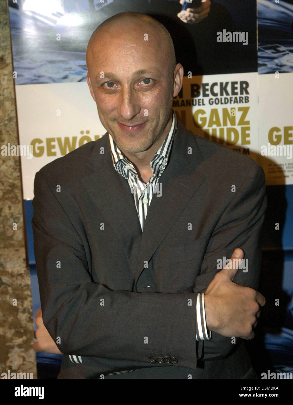 Oliver Hirschbiegel poses in front of a film poster ahead of the premiere of his new film 'Ein ganz gewoehnlicher Jude' (a totally common jew) in Hamburg, Germany, Thursday, 19 January 2006. The film, based on the novel of the same name by Swiss author Charles Lewinsky, deals with the story of Emanuel Goldfarb, a Jew who is invited by a school class to talk about is identity. His l Stock Photo