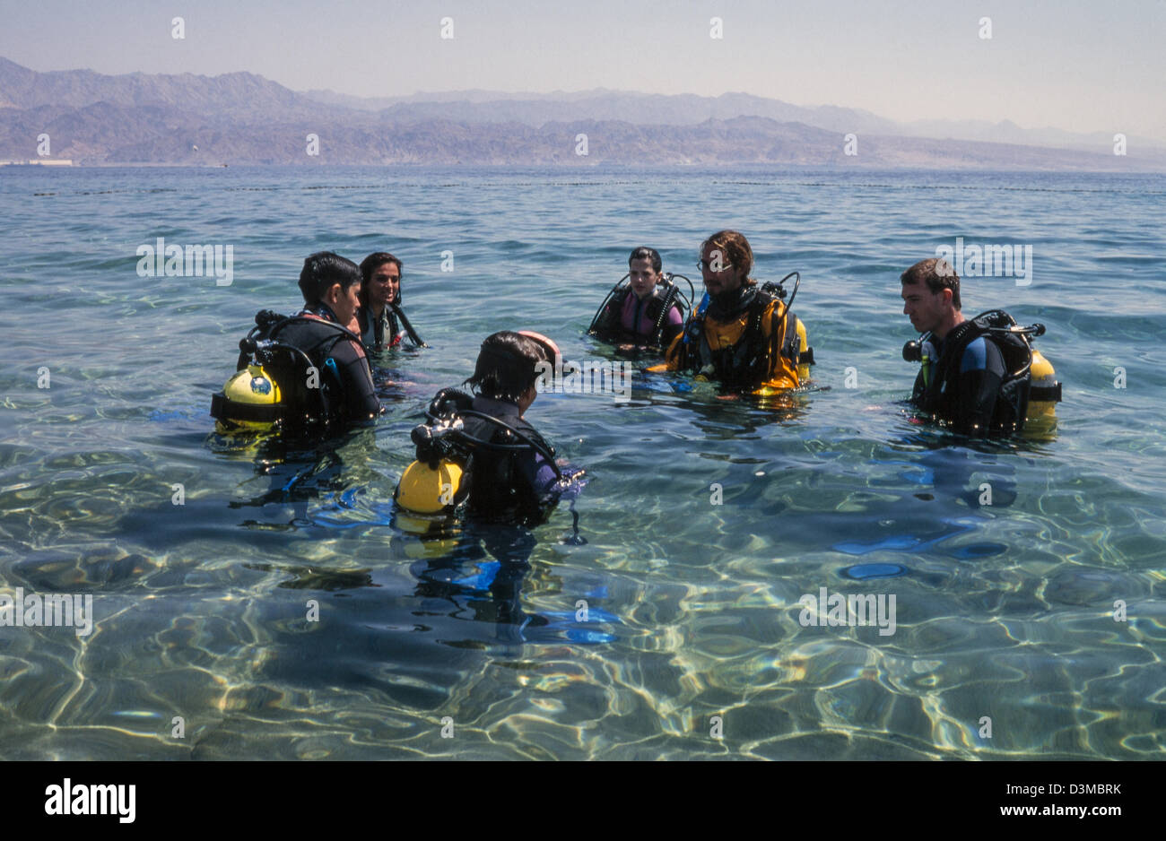 Beginners in diving instructed by the teacher. Stock Photo