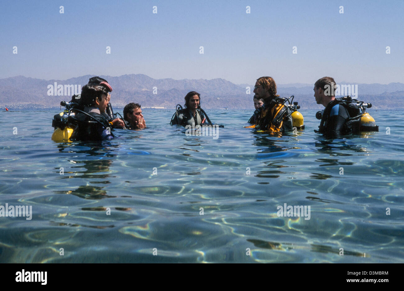 Beginners in diving instructed by the teacher. Stock Photo