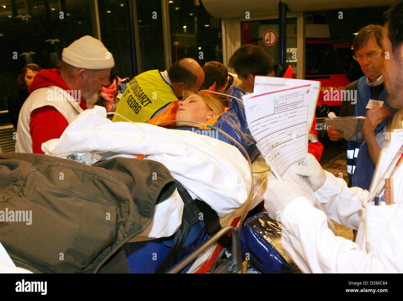 Rescue forces take care of 'injured' participants of an hospital disaster drill in Hamburg, Germany, 25 January 2006. The scenario for the practise conformed to 50 injured people after two bombings in Hamburg. According to the local health authority terrorist bombings in two public-transport busses were assumed. The bombs shall have been so-called dirty bombs unleashing radioactive Stock Photo