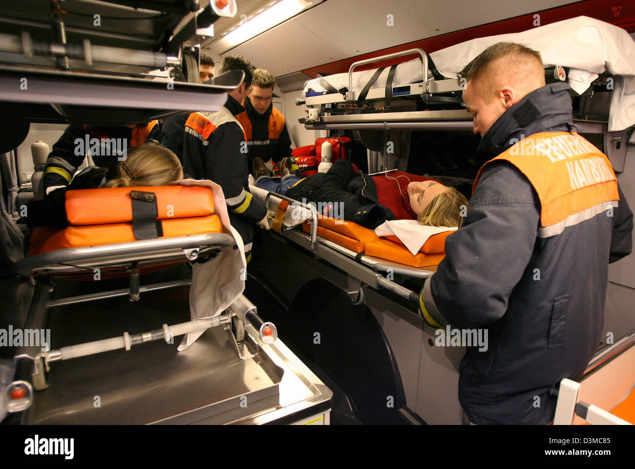 Rescue forces take care of 'injured' participants of an hospital disaster drill in Hamburg, Germany, 25 January 2006. The scenario for the practise conformed to 50 injured people after two bombings in Hamburg. According to the local health authority terrorist bombings in two public-transport busses were assumed. The bombs shall have been so-called dirty bombs unleashing radioactive Stock Photo