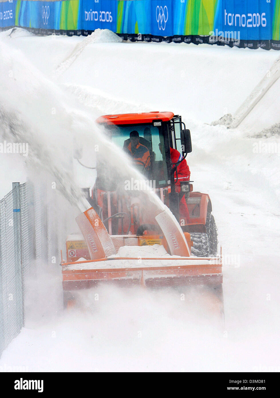 A snowblower clears the pathway for the spectators in Pragelato, Italy, Monday, 06 February 2006. The Olympic disciplines Nordic Combined and Ski Jumping are going to take place at this location from 10 February to 21 February. Final preparations are underway for the opening of the XX Winter Olympics on 10 February. Photo: Arne Dedert Stock Photo