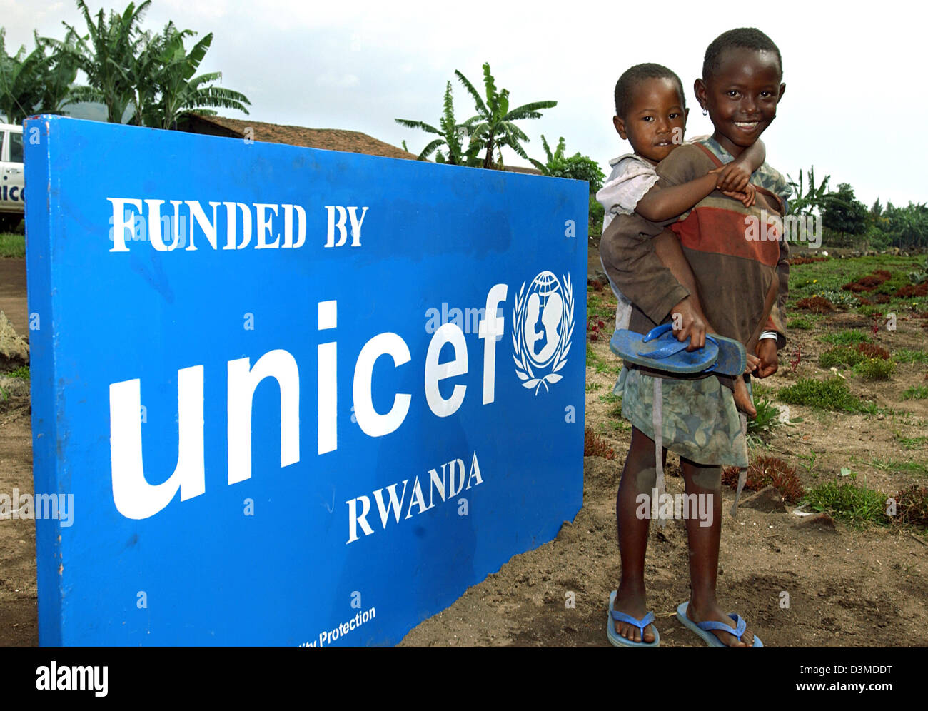 Siblings Rwanda The picture shows a girl who carrys her younger sibling, standing ...