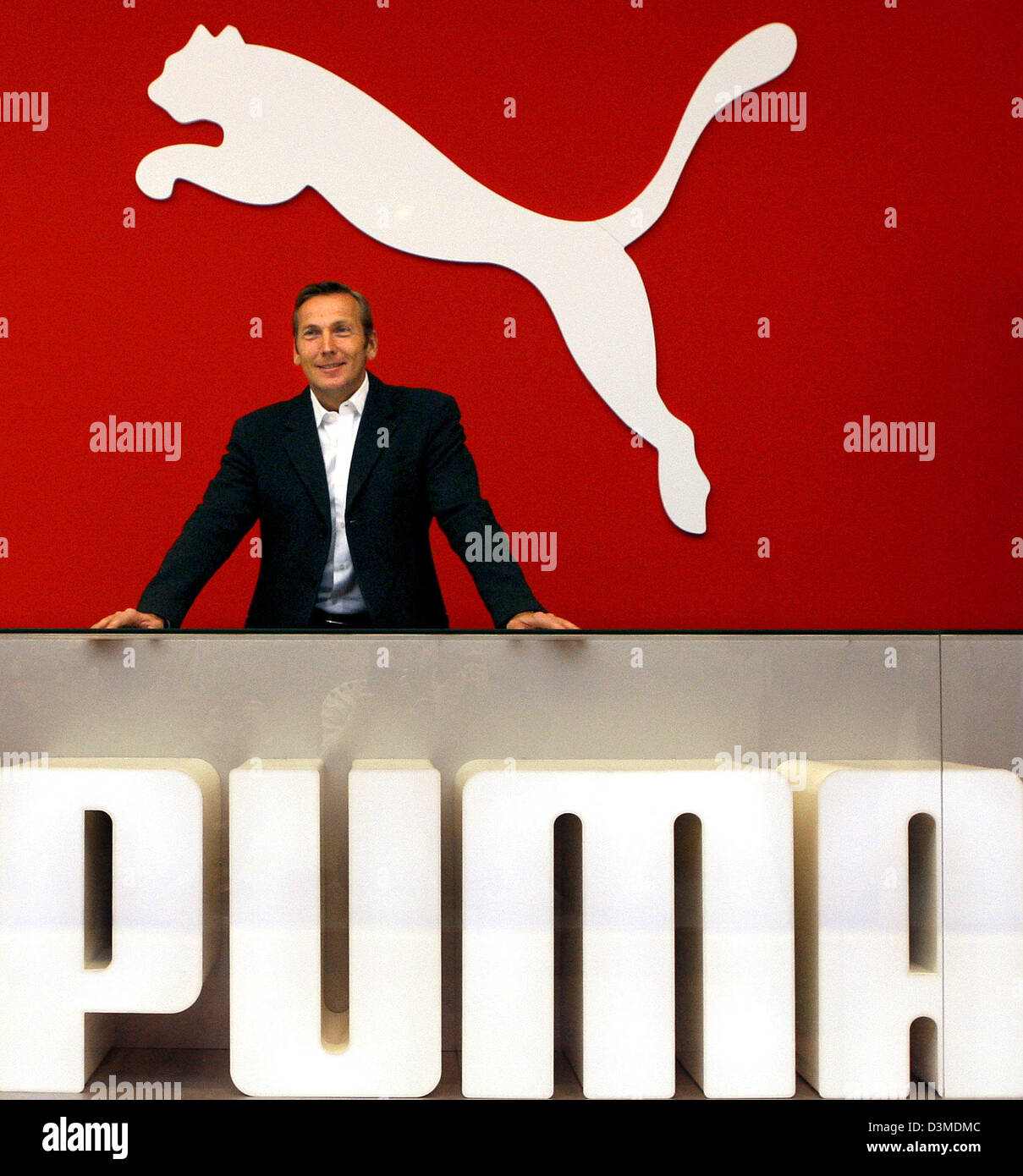 Sporting goods company Puma AG chairman Jochen Zeitz smiles below the Puma logo prior to the company's balance press conference in Nuremberg, Germany, Friday 10 February 2006. According to Zeitz the company achieved record results in the business year 2005. Photo: Daniel Karmann Stock Photo